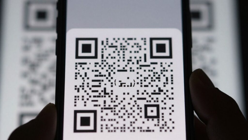 Smartphone scanning a QR code.