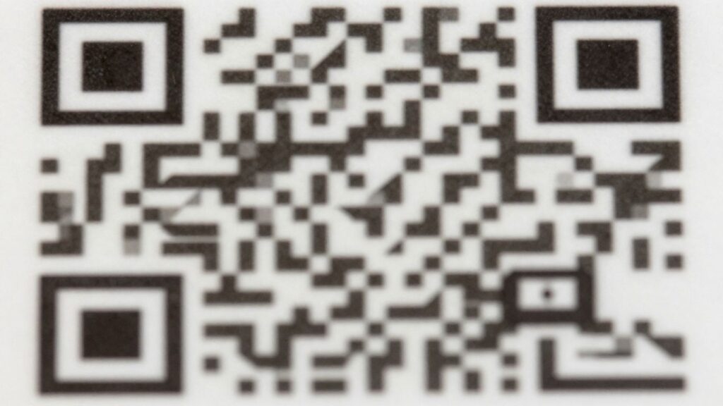 Close-up of a QR code's geometric pattern.